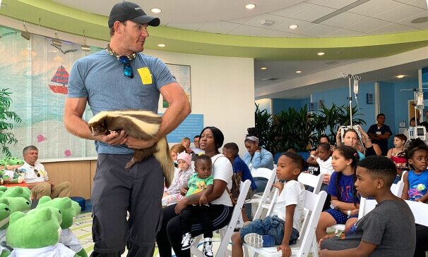 alligator expert teaching everglades animal safety to a room of Florida alligator park visitors