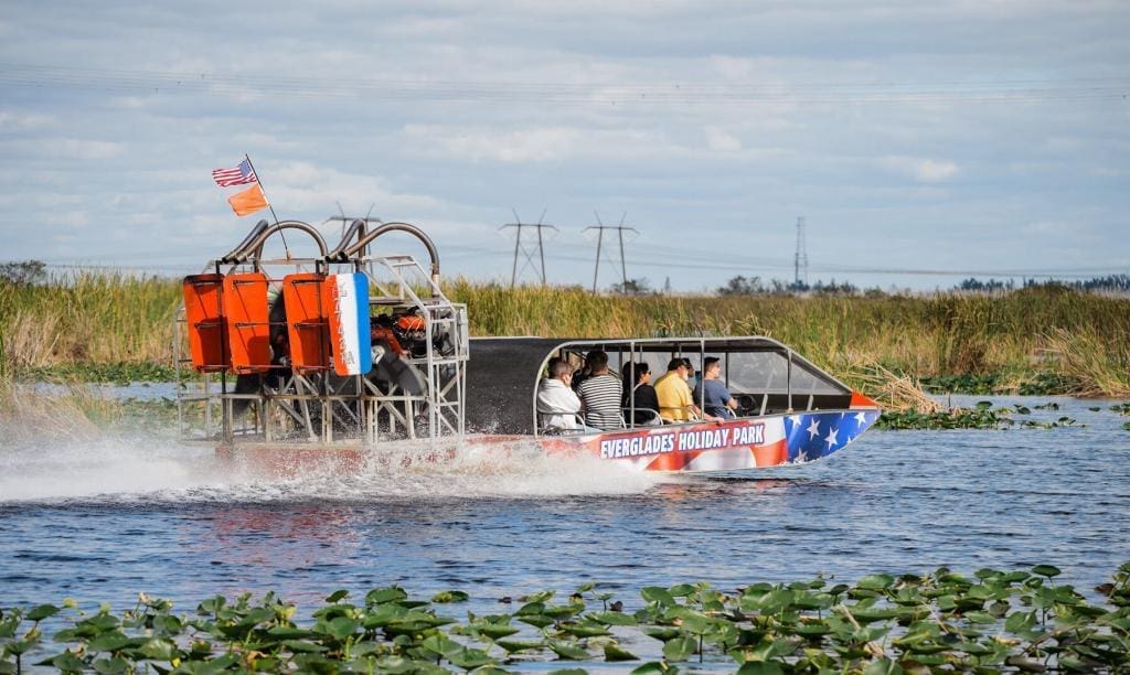 Airboat Carrying Tourists Through Everglades Waterways
