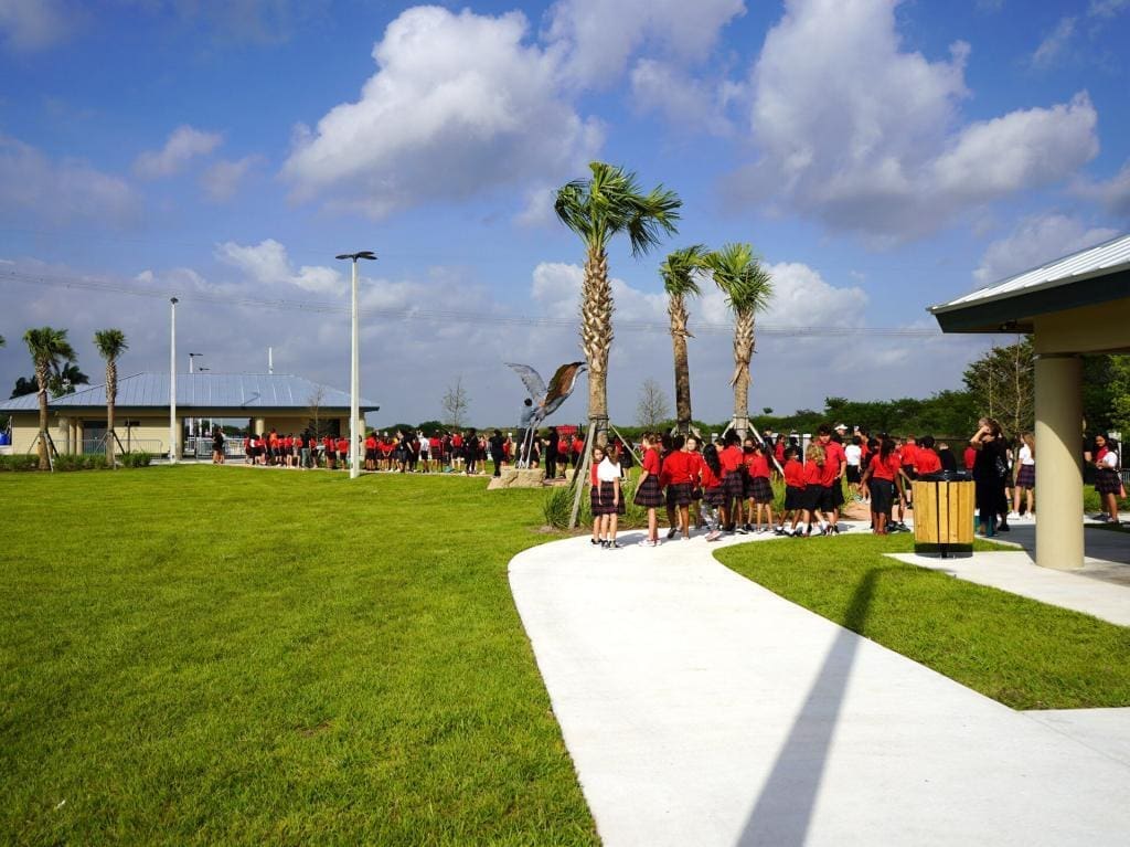 Group of students in red uniforms lined up for an Everglades field trip